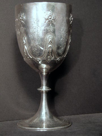 English Sterling Silver Embossed Repousse Goblet: English sterling silver goblet with a full set of hallmarks for London 1881, maker William Evans. The outside of the bowl being decorated with repousse rosettes and bright work, the inside is gold was