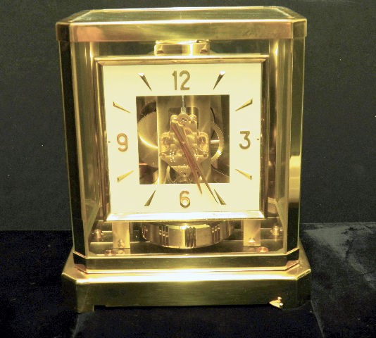 Jeager LeCoultre Atmos Mantle Clock: A square dial Le Coultre Atmos Mantle clock with its original travel box. Square dial. Serial # 130867 Calibre 528-6. Made 1960's. Clean case but fluid missing from level.All clock movements sold as i