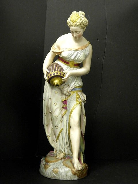Large Bisque Chelsea Figure of A Young Woman: A large bisque porcelaine chelsea figure of a grecian woman standing on a naturalized base emptying her urn into a stream with reeds behind her. Call for shipping.Green anchor mark and AR mark to Base