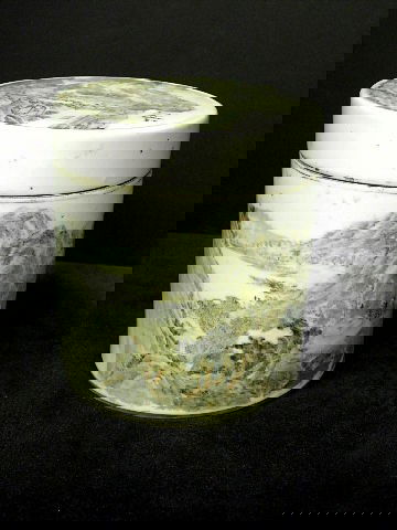 Chinese cylindrical Box & Cover Depicting Landscape: A chinese cylindrical box and cover. The white ground painted with a mountains, houses and trees surrounding a lake. Script to back of box and signature to base. Note: chip to lid and hairline to body