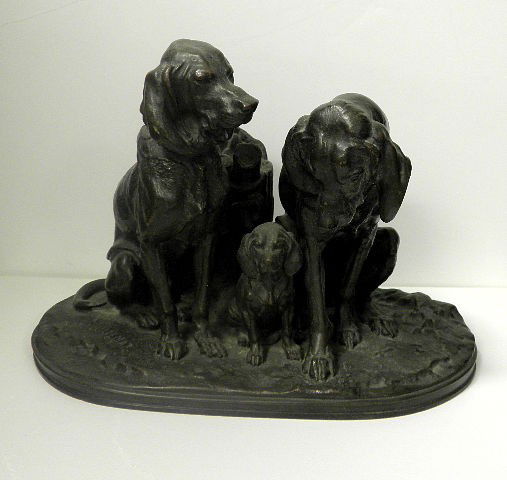A Jacquemart Bronze of Three Bloodhounds: A well case bronze of a dog, bitch, and their pup seated in front of a tree stump. Signed A. Jacquemart. Good brown patina. Alfred Jacquemart (1824-1896) born Paris approximately 2"-4". Feb 24th 1824.