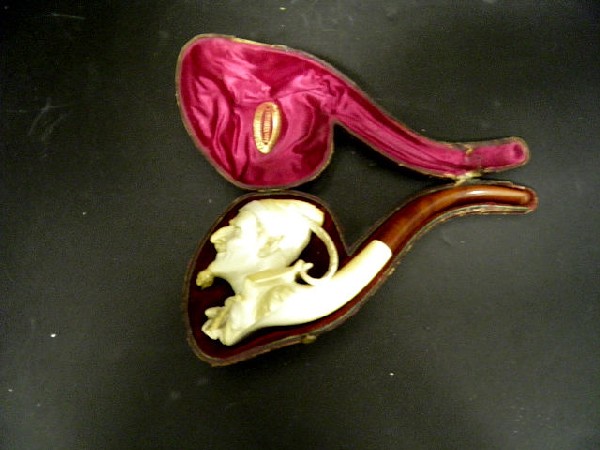 Good Cased Figural Meerschaum Pipe: Antique figural Meerschaum pipe in it's original case with a Swiss retailers stamp. The bowl ornately carved as a Barron Munchausen type character with a large nose, pointed ears, hat, and a goatee, m