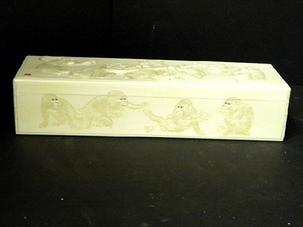 Large Oriental Ivory signed box and cover: Fantastic oblong oriental ivory box. The top and front exquisitely carved with groups of monkeys fighting over food. The lid having a red seal signature. Not for export. Measures approx. 3" high X 14"
