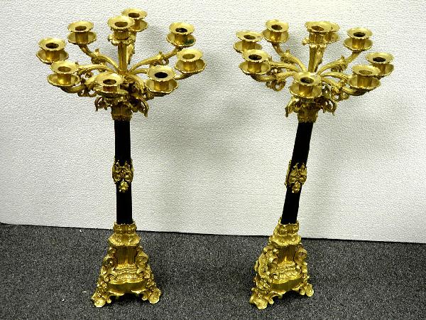 A good pair of bronze dore bronze candelabra: A pair of eight branch bronze and dore bronze candelabra. The dore bronze tops and base decorated with swags and scrolls and acantaus leaves. Measures approximately 26" high and 12 1/2" wide.