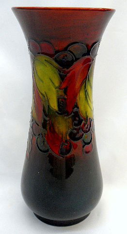 Moorcroft Pottery Dark Colored Hand Painted Vase: Moorcroft hand painted pottery vase in a stunning floral type motif. The entire floral design is accented by a spectacular red & black backround. SHIPPING & REQUIRED INSURANCE $25.00 WITHIN THE CONTIN
