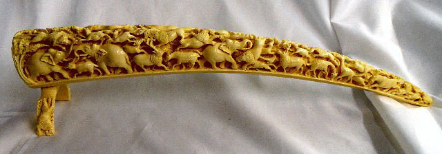 African Hand Carved Ivory Figural Tusk: Intricately Carved Ivory Figural Tusks Depicts All Types Of Animals. Leans On An Ivory Stand. Measures 20 1/4" L. Ranging From 7/8" to 2 7/8" Wide. 2 " Height On Stand. Shipping and Required Insurance