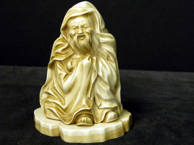 Stained Ivory Figure: Craved ivory figure of a smiling old man wearing a hooded cloak. This is a heavy solid carving. Measures 5" high and 4" wide. Please note: No international shipping.Contact for shipping quote. NO Inte
