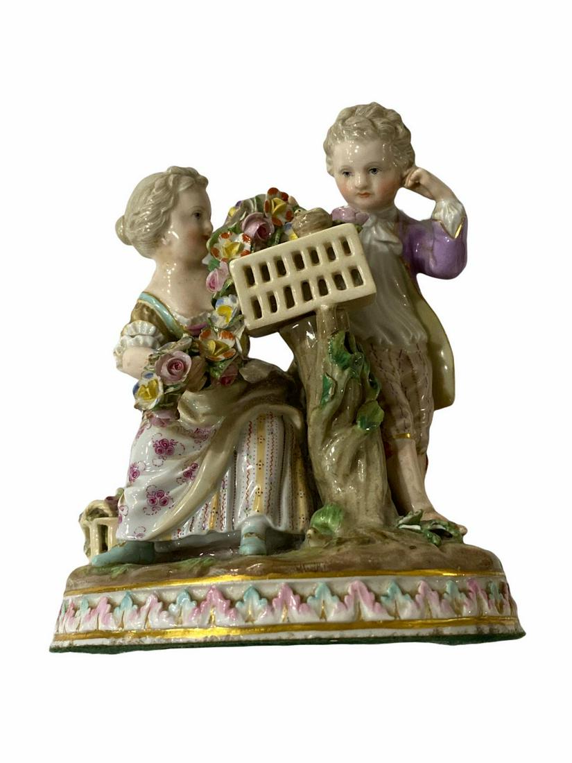 Meissen Porcelain Figurine Group of a Young Boy and Girl with Bird Cage: Meissen Porcelain Figurine Group of a Young Boy and Girl with Bird Cage measures H: 6". Some leaves have chips, sold as is.