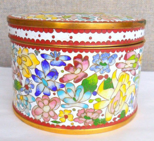 Cloisonne Round Covered Trinket Box: Cloisonne round covered box. This box has a multi color flower design throughout. Gilt trimming and border with a royal blue color interior. Has a diameter of 5 1/4 inches x 3 5/8 inches height. Shipp