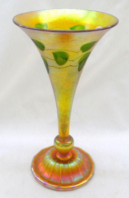 L.C. Tiffany Favrile Intaglio Cut Art Glass Vase: Signed Tiffany Favrile gold iridescent vase #7497L with an etched and painted Intaglio cut around the upper portion of the vase. It has an intaglio cut and measures approx 12" tall and is in very good