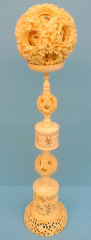 Carved Ivory Chinese Puzzle Ball with Stand: Intricately and painstakingly carved Chinese puzzle ball with an equally impressive stand. Measure 19" tall. The puzzle ball has a damaged/broken layer inside, otherwise is in very good condition. Shi