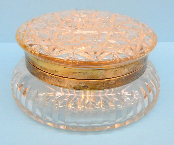 Antique CF Monroe Dresser Box: Large round CF Monroe brilliant cut glass/crystal dresser box. The band is made of sterling silver and is marked; CFM Co and Sterling. Measures 8" diameter and is in very good condition. Shipping With