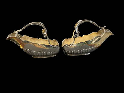 Matching Pair of Buccellati Sterling Silver Wine Cradle's with Shell Handles: Matching Pair of Buccellati Sterling Silver Wine Cradle's with Shell Handles weighs 28 OZT. Each cradle measures approx. 7 3/4" height x 11 1/2" length x 4 3/8" width overall including handles.