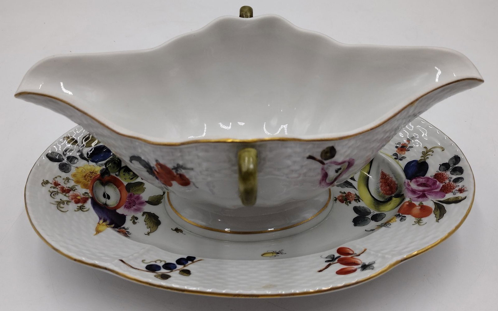 Herend Hungarian Hand Painted Fruits & Flowers Gravy Boat: Herend Hungarian hand painted handled gravy boat with attached underplate in a fruits and flowers pattern. Blue shiled and crown mark to bottom with incised 932 numbers. Measures approx. 4" height x 1