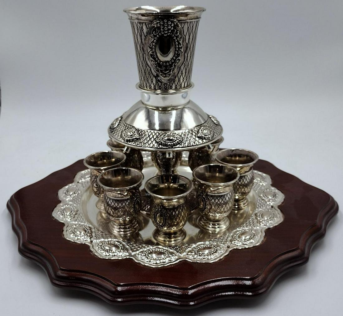 Silver Plate Judaica Kiddush Wine Fountain with Central Wine Cup and Eight Smaller Cups: Silver Plate Judaica Kiddush Wine Fountain with Central Wine Cup and Eight Smaller Cups measures H: 9" x DIA: 11"