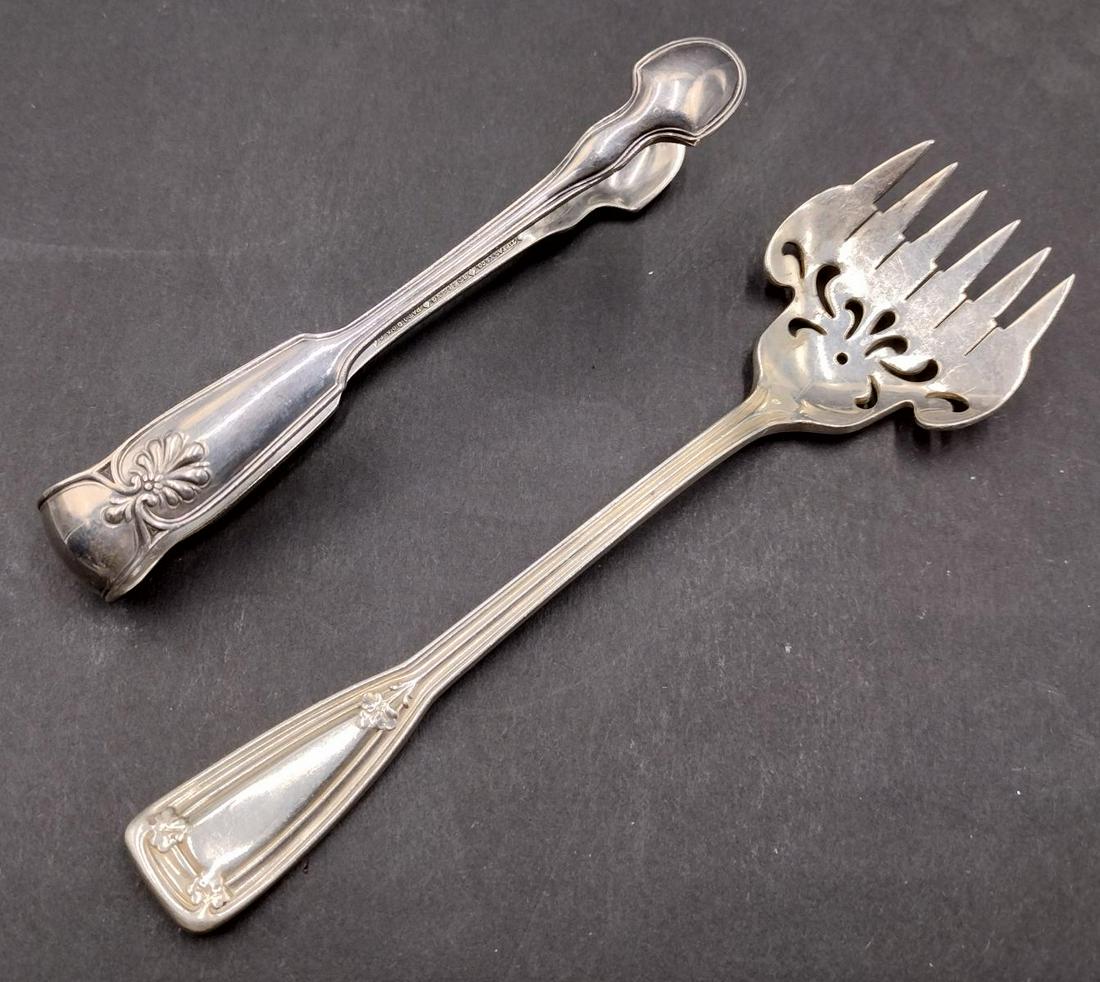 2 Tiffany & Company Sterling Silver Flatware Serving Items: A lot of 2 Tiffany and Company sterling silver flatware serving items. Lot is to include sugar tongs (4 1/4") in the "Shell And Thread" pattern and sardine fork (5 1/2") in the "St. Dunstan" pattern.
