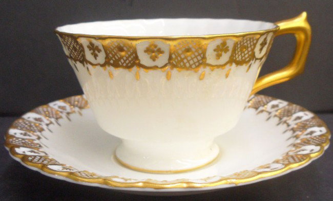 Royal Crown Derby Cups and Saucers (6): Set of six english fine bone china cups and saucers with regal raised gold design on the borders and on the handles of the cups. Royal Crown Derby seal on bottom. Made in England. Measures, cups - 2 1