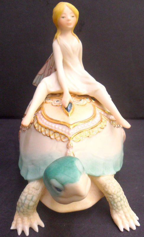 Vintage Cybis Winged Fairy on Turtle: Vintage cybis porcelain figure of a winged fairy riding on the back of a turtle. The turtle and fairy are cream colored with mint green, turquoise, yellow and gilt accents. Cybis signed on bottom. Mea