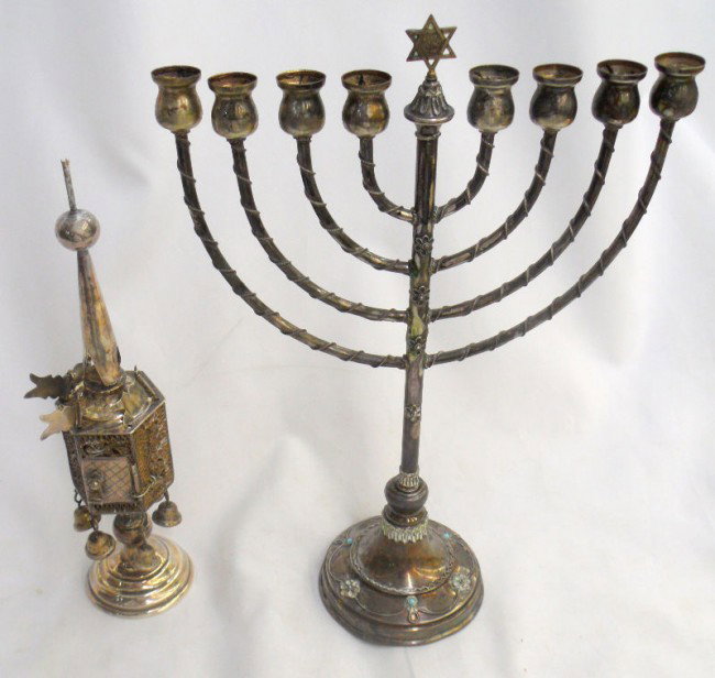 Sterling Silver Spice Box and Menorah: Striking sterling silver spice box or tower with intricate filigree and a sterling silver menorah with turquoise accents on the base. Both of these pieces of Judaica are being sold as-is. Measures , s