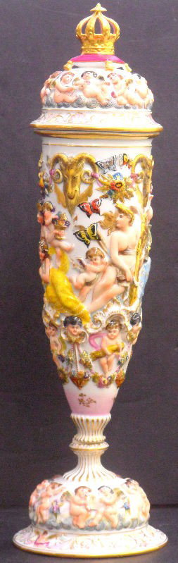 Impressive Capodimonte Porcelain Covered Vase: Impressive Capodimonte porcelain covered vase having raised figures throughout, has mark of N for king of Naples. Measures 18 1/2" high. Shipping within the continental US is $50 plus Required insuran