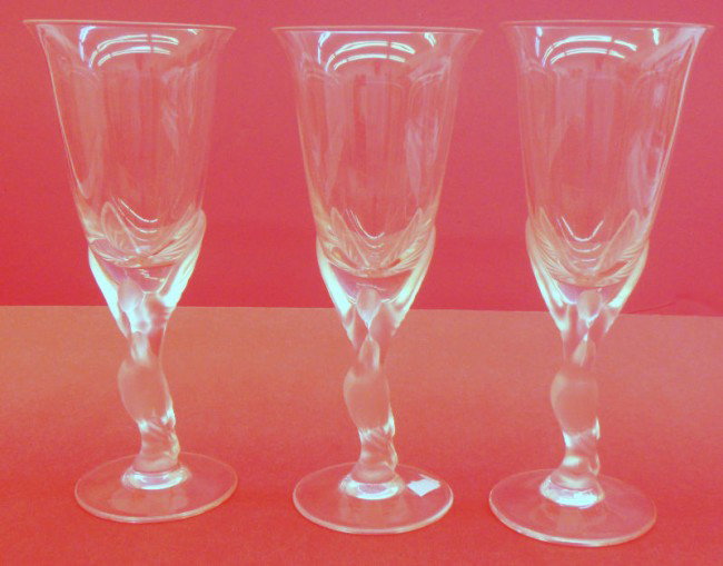 3 Lalique Crystal Figural Champagne Flutes: Lalique Crystal Champagne Flutes with Dore figures on its stems. Signed Lalique France. Measures 8 1/4" high x 3" wide. Shipping within the continental US is $25 plus Required insurance. For internati