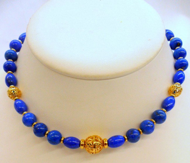 14K Y.G. Lapis Lazuli Necklace: 14K Yellow gold all around oval rondel cabochon & bead lapis lazuli necklace. This necklace features pierced 14k gold balls seperated by alternating patterns of lapis lazuli.Necklace easures 15" & wei