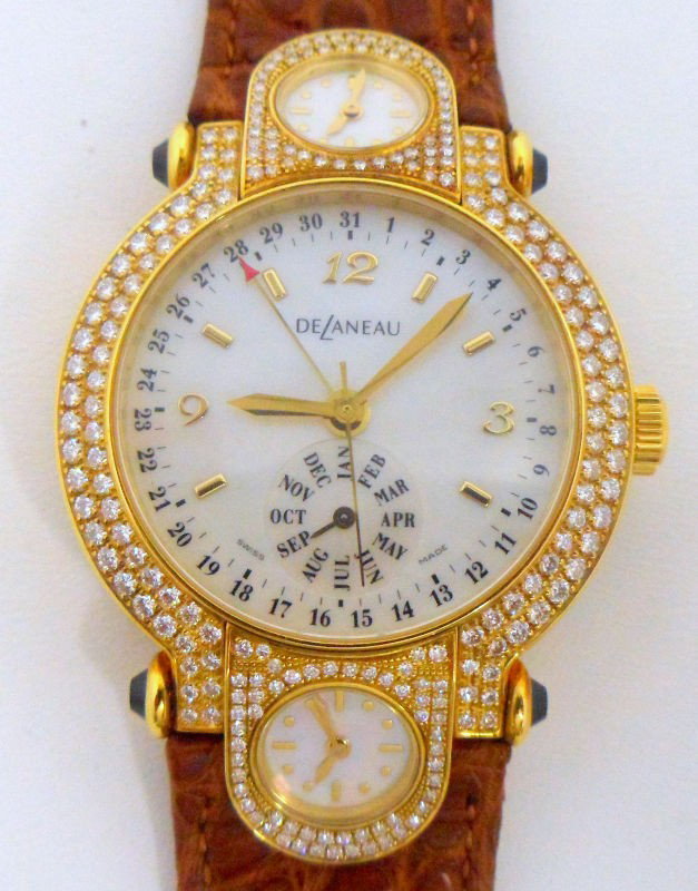 18K Y.G. Delaneau Diamond Watch: 18K Yellow gold Delaneau Three Time Zone watch. This watch features a solid 18K yellow gold face with diamond pave bezel accented with blue sapphire outer lugs. Diamonds have a combined total weight o