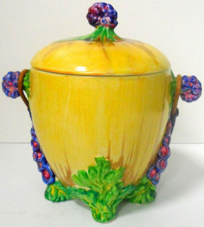 Clarice Cliff "My Garden" Biscuit Barrel: An absolutely stunning Clarice Cliff Biscuit Barrel entitled "My Garden", produced in 1935. Relief moulded feet. The piece features the bold colors that Clarice Cliff is known for, including yellow, g
