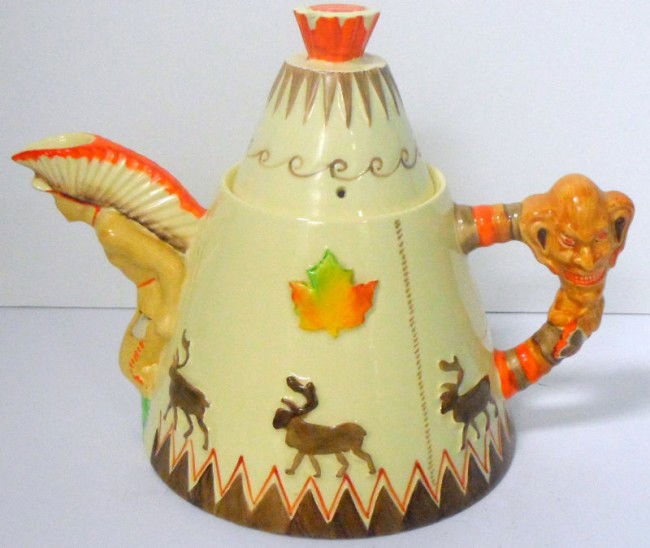 Clarice Cliff Tee Pee Tea Pot: English ceramic industrial artist Clarice Cliff Tee Pee Tea Pot. The spout modelled as an Indian with full headdress. The handle as a totem pole and the body having moose design in relief. Signed on b