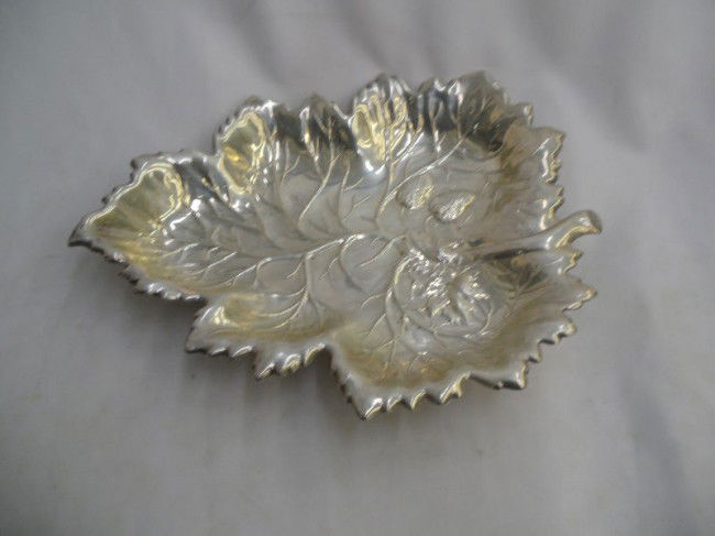 Magnificent Sterling Silver Dish: This magnificent sterling silver dish would look great on any table. It features a stunning leaf design with an even more detailed strawberry design near the base of the leaf. Measures 1 5/8" high x 9
