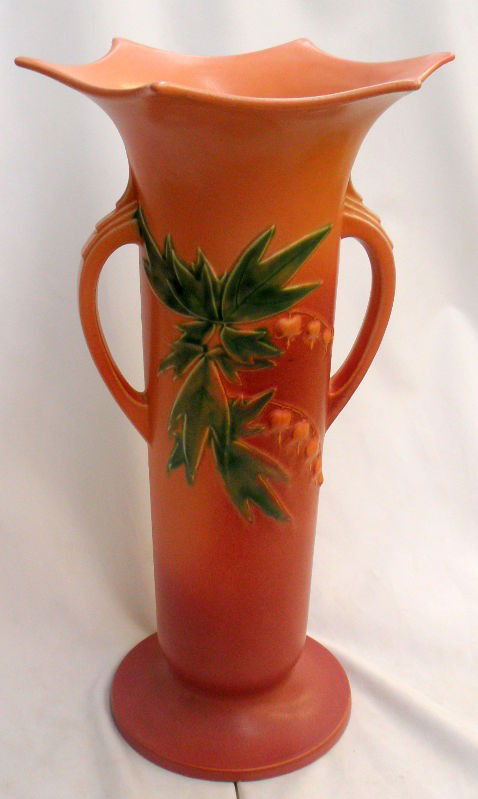 Rare Roseville Pottery Two-Handled Vase: This rare, impressive large Roseville pottery vase is highly desirable. It features a graduated rose color backround with a holly design in both the front and back. Its exceptional art deco form has g