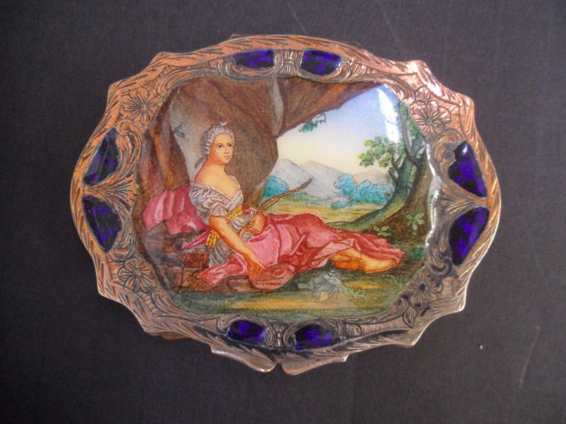 800 Silver and Enamel Compact: Beautiful 800 Silver and Enamel compact has very pretty cobalt blue enamelling around border with a painted lady in center lounding on the grass in front of a tree. On back it has beautiful scroll des