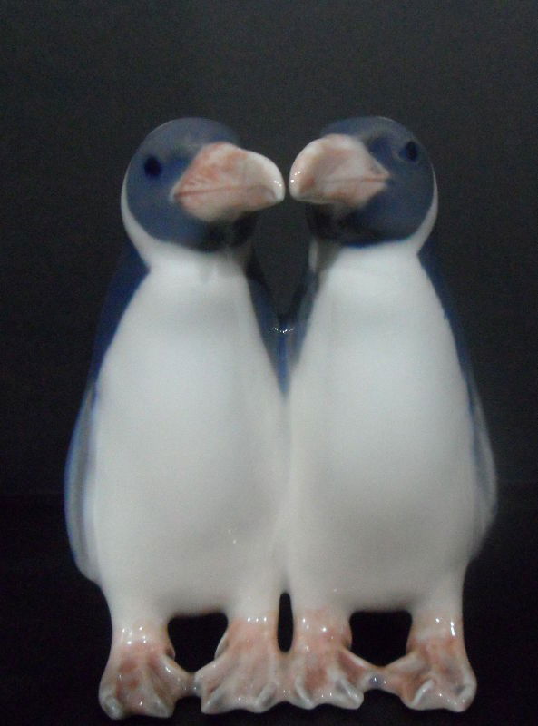 Royal Copenhagen Porcelain Penguins #1190: This pair of porcelain penguins was produced in Denmark by Royal Copenhagen in 1964. Model #1190. Royal Copenhagen logo on bottom. Measures 3 3/4" high x 3" wide. Shipping within the continental US is
