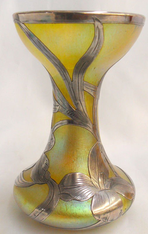 Sterling Silver Overlay Vase: This vase is an exceptional and fine example of sterling silver overlay. It features a green iridescence on the body of the vase covered with intricate sterling silver overlay. Being sold as is, Pleas