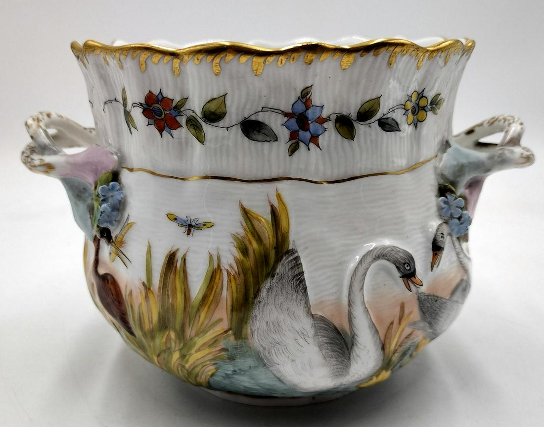 Fine 19th Century Capodimonte Swans Porcelain Handled Bowl: A finely crafted and hand painted antique Capodimonte handled mint bowl depicting raised swans in pond with insects and cat tails. Copleted with raised flowers. Blue underglase Napoli mark to bottom a
