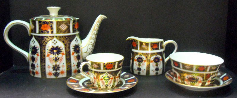Royal Crown Derby Imari China (21 pcs.): Royal Crown Derby set of English bone China. In the Imari pattern # 1128. Comprises of 6-3 pc. Place settings including tea cups, tea saucers, bread and butter plates, plus open sugar bowl, creamer an