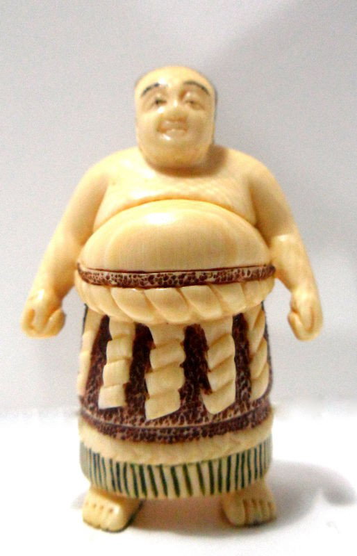 Chinese Carved Ivory Netsuke: Chinese carved ivory netsuke depicting a fat man. Signed on back. Measures 2 1/4" high. Shipping within the continental US is $15 plus required insurance. No international shipping.