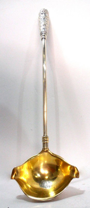 Gorham Sterling Silver Punch Ladle: A Gorham sterling silver punch ladle, circa 1875. A large serving piece with a deep bowl inscribed with initials. The end of the handle is decorated with a floral pattern depicting lillies. The Gorham