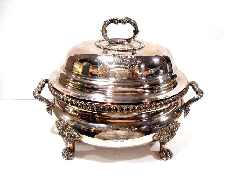 Antique English Sterling Tureen: Antique English Sterling Tureen 19th century by Henry Holland. The set includes 3 pieces. The lid and base are beautifully chased with a family crest on one side and the family motto on the other. The