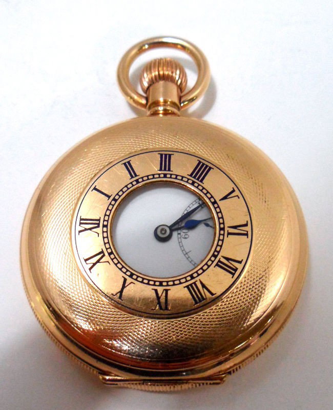 Dennison Watch Co. Pocket Watch: 17 jeweled Dennison Watch Co. enamel dial with roman numbers with sub second hand. Watch is in working order & has unique scroll work on back of case. Shipping within the continental US is $20 plus Re