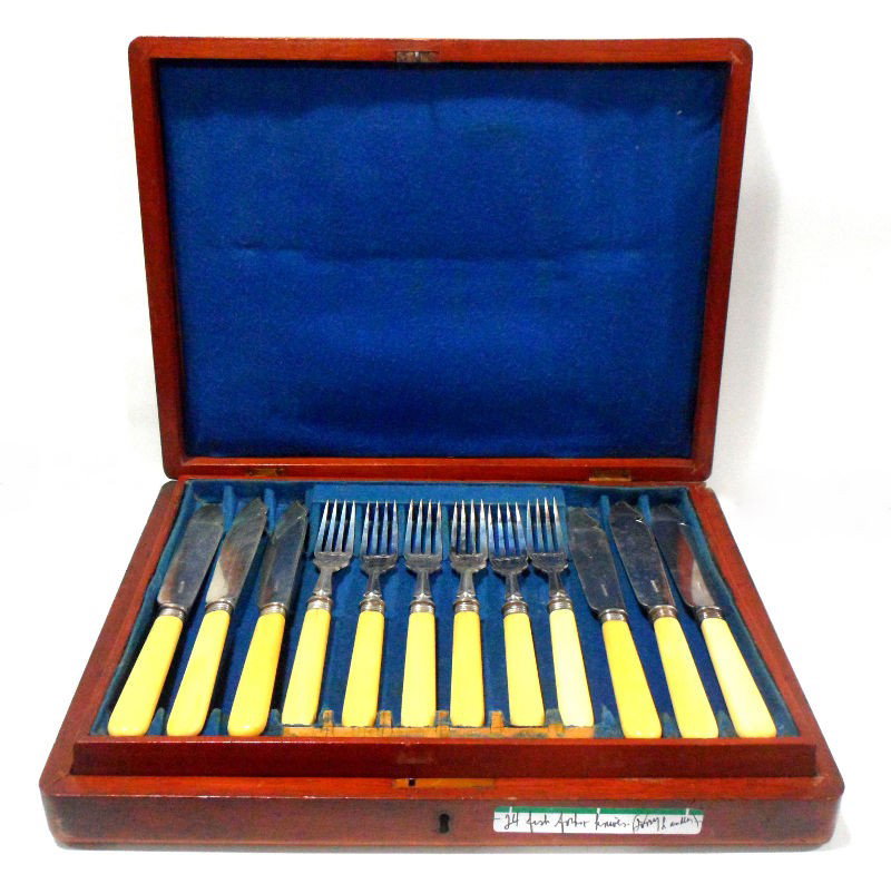 Silver and Ivory 24pc Fish Fork and Knife Set: A Silver and Ivory 24pc Fish fork and knife set. The set is presented in a wood box with a bronze cartouche on the top. Each piece is beautifully crafted. The hallmarks found on each plate are "WH&S B
