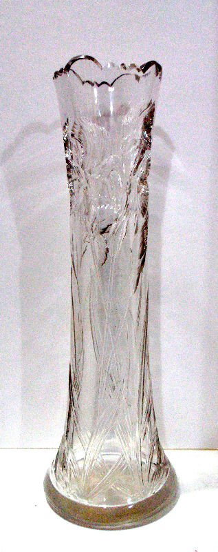 Webb Crystal Vase: A beautiful antique Webb cut crystal vase. Lilies have been cut into the glass and extend along the length of the vase. Please note there is a minor chip on the base. 43 1/2" X 13" X 9". Shipping with