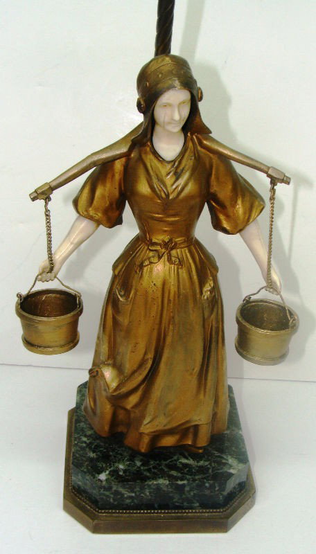 Mulenbeck Doré Bronze and Ivory Sculptural Lamp: A doré bronze and ivory sculptural lamp signed by Mulembeck. The piece was originally a free standing scultpture, but it has been turned into a lamp. The figure is of a provincial milkmaid, and she i