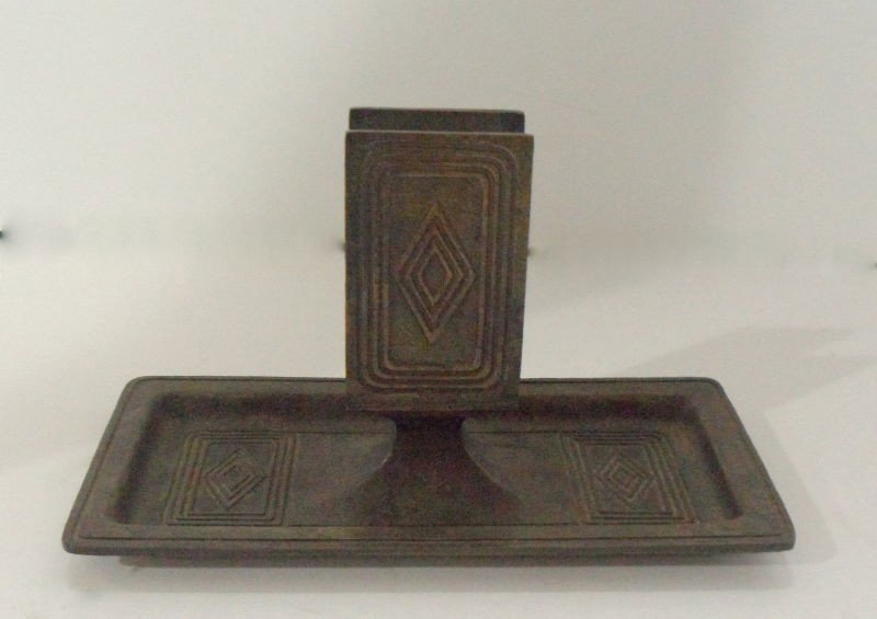 Tiffany Studios Bronze Matchbox Holder: Tiffany Studios bronze matchbook holder in the rare geometric pattern. The recessed tray features the same patter as the holder. Felt covered base. 3 1/2"H, 6 1/4"L. Shipping within the continental US