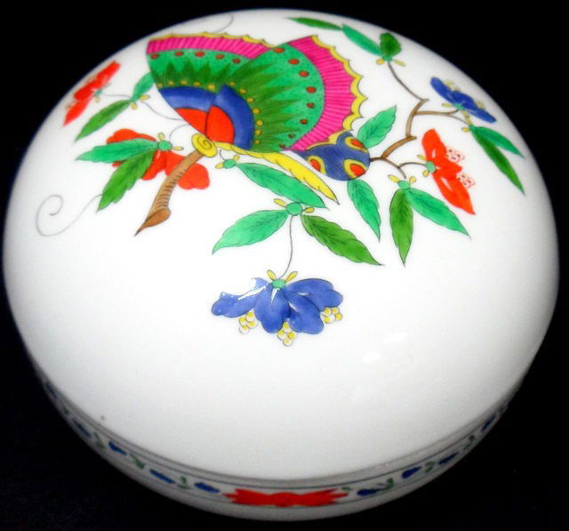 Meissen Hand-painted Porcelain Butterfly Dish: Beautiful hand-painted Meissen covered dish with butterfly design on cover and underglaze crossed sword mark on bottom. Marked with Herend logo on bottom. Made in Hungary. Measures 3 1/4" high x 5" di