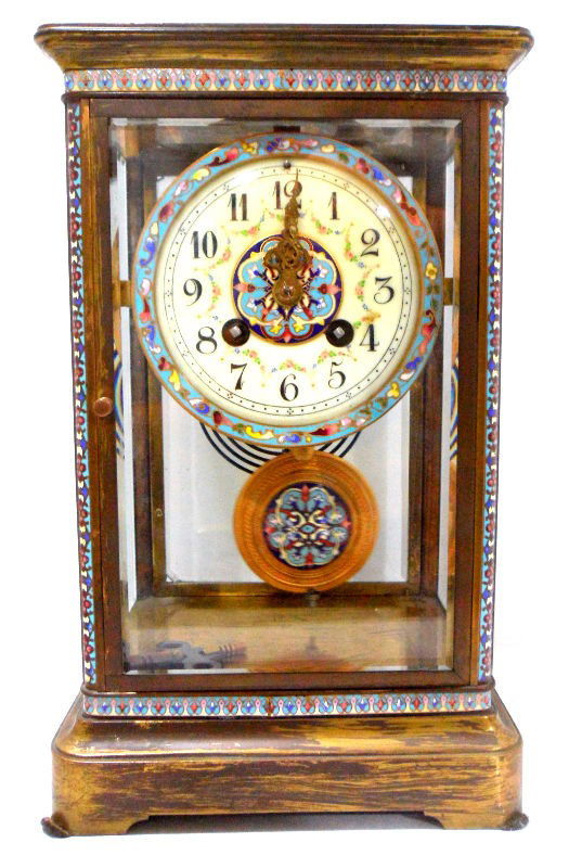 French Champlevé Regulator Clock: French champlevé regulator clock. The time piece is surrounded by a brass case with four glass walls; the outer borders of the case contain beautiful champlevé work. The brass pendulum is patterned