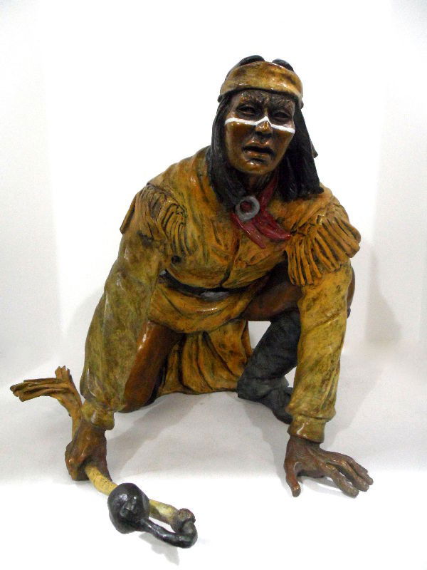 Marie Barbera Bronze of a Native American: Marie Barbera bronze sculpture of a Native American. The figure is in an active squatting positions, and holds a weapon. He is dressed in traditional Native American costume, and his face is painted.
