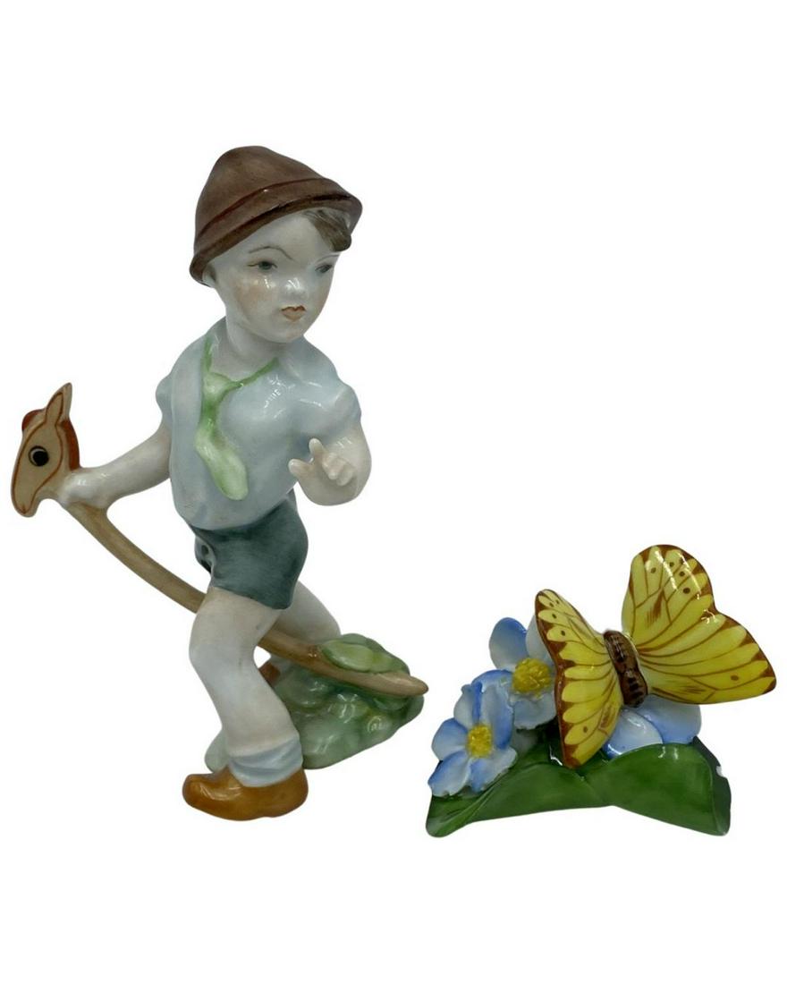 Pair of Herend Hungary Hand Painted Porcelain Figurines: Pair of Herend Hungary Hand Painted Porcelain Figurines includes boy playing with stick horse H: 4", butterfly with flowers H: 1 1/2". Both pcs have damage, sold as is