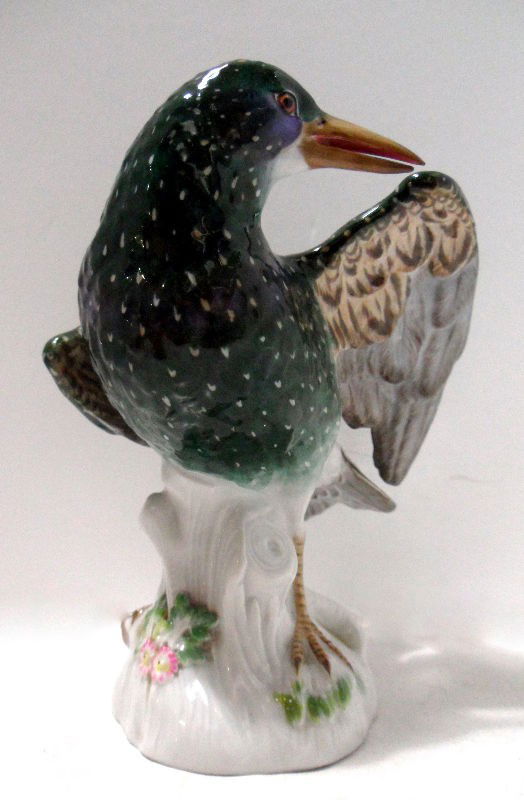 Meissen Porcelain Model of a Starling Bird: Late 19th century Meissen porcelain model of a starling bird. The bird is perched astride a tree stump blue crossed sword mark on bottom. Model #974 Measures 8 1/4" high. Shipping within the continent