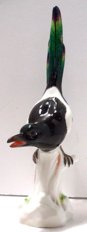 Meissen Porcelain Model of a Jay Bird: Late 19th century Meissen porcelain model of a jay bird. The bird is perched astride a tree stump blue crossed sword mark on bottom. Measures 8 1/4" high. Shipping within the continental US is $25 plu